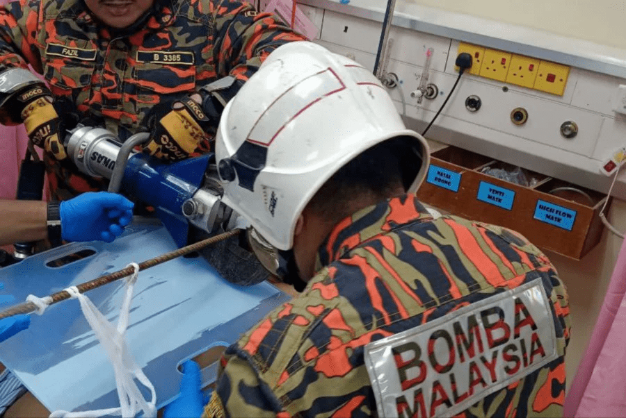 Firefighters removing steel bar from Azlan's head