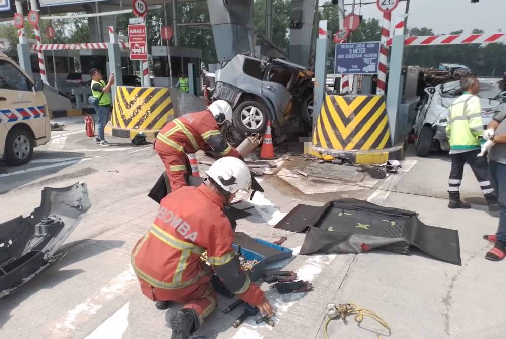Firefighters working at Bukit Kajang Toll Plaza crash scene