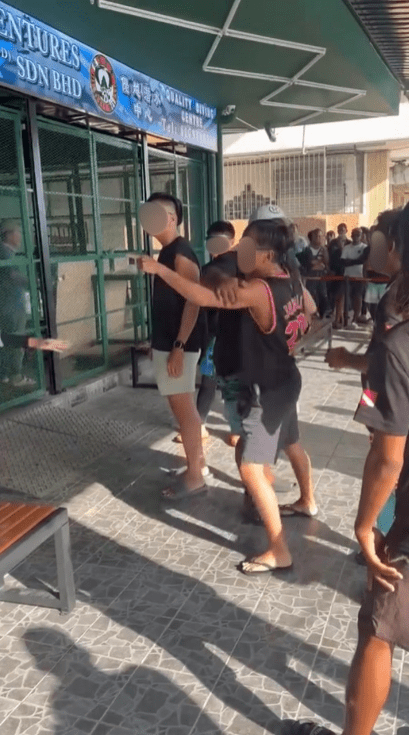dive instructor semporna arrested for hitting tourist restrained