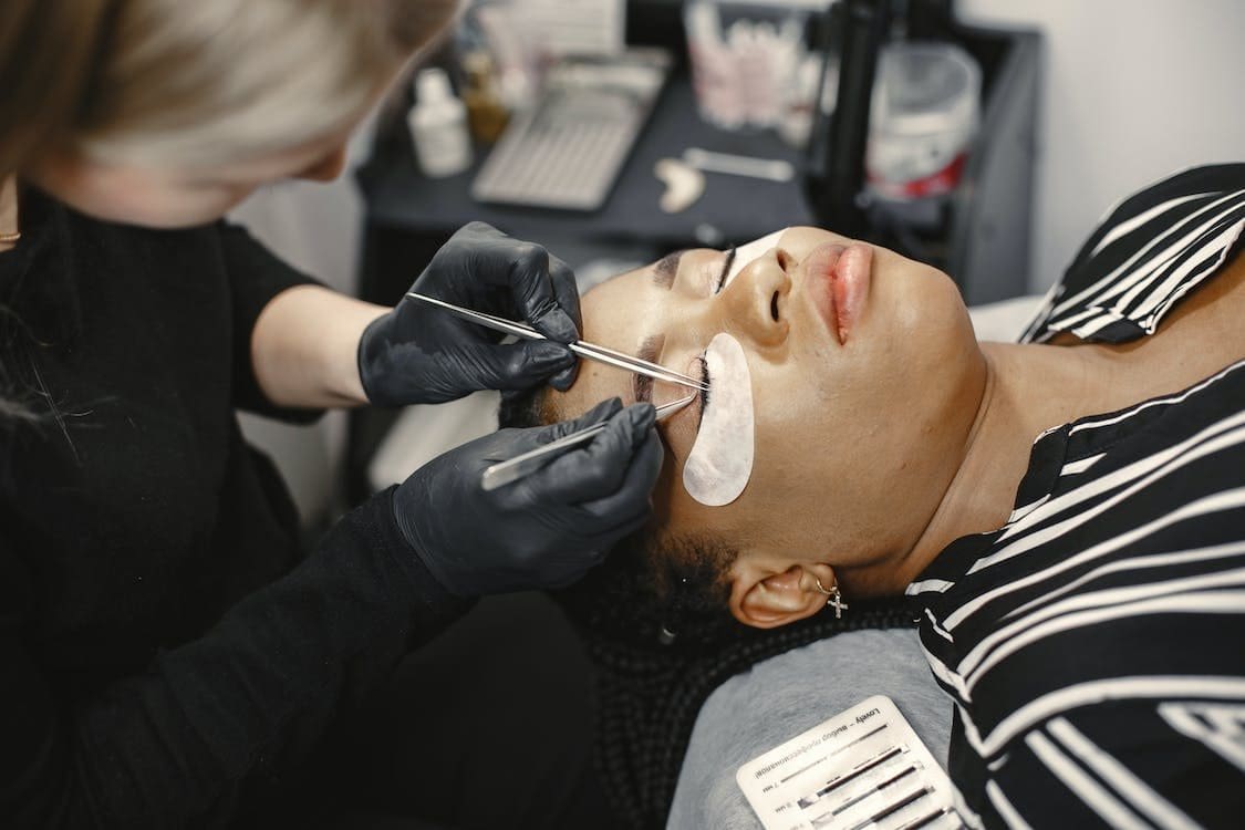 Woman having eyelash extensions
