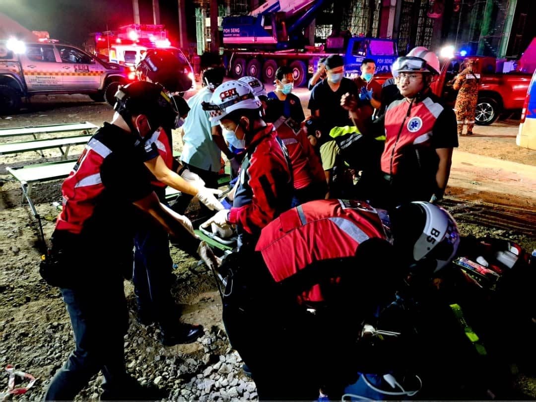 Rescuers helping victims after building collapses in Penang