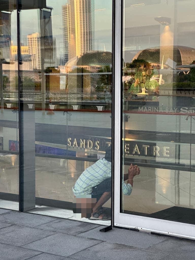 Man pooping at Marina Bay Sand