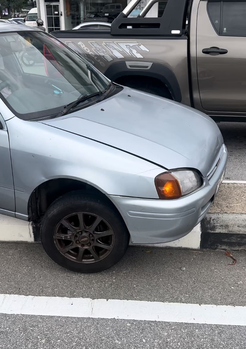 Car stuck on road divider