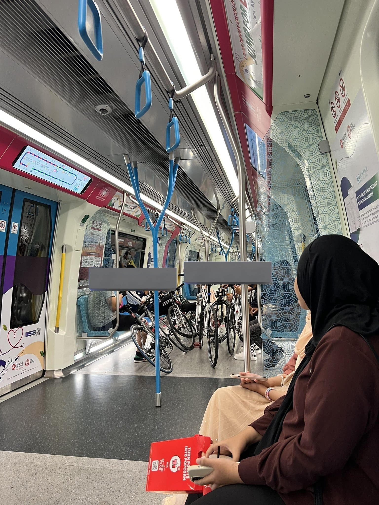 Male cyclist bringing in their bicycles in MRT Women's coach
