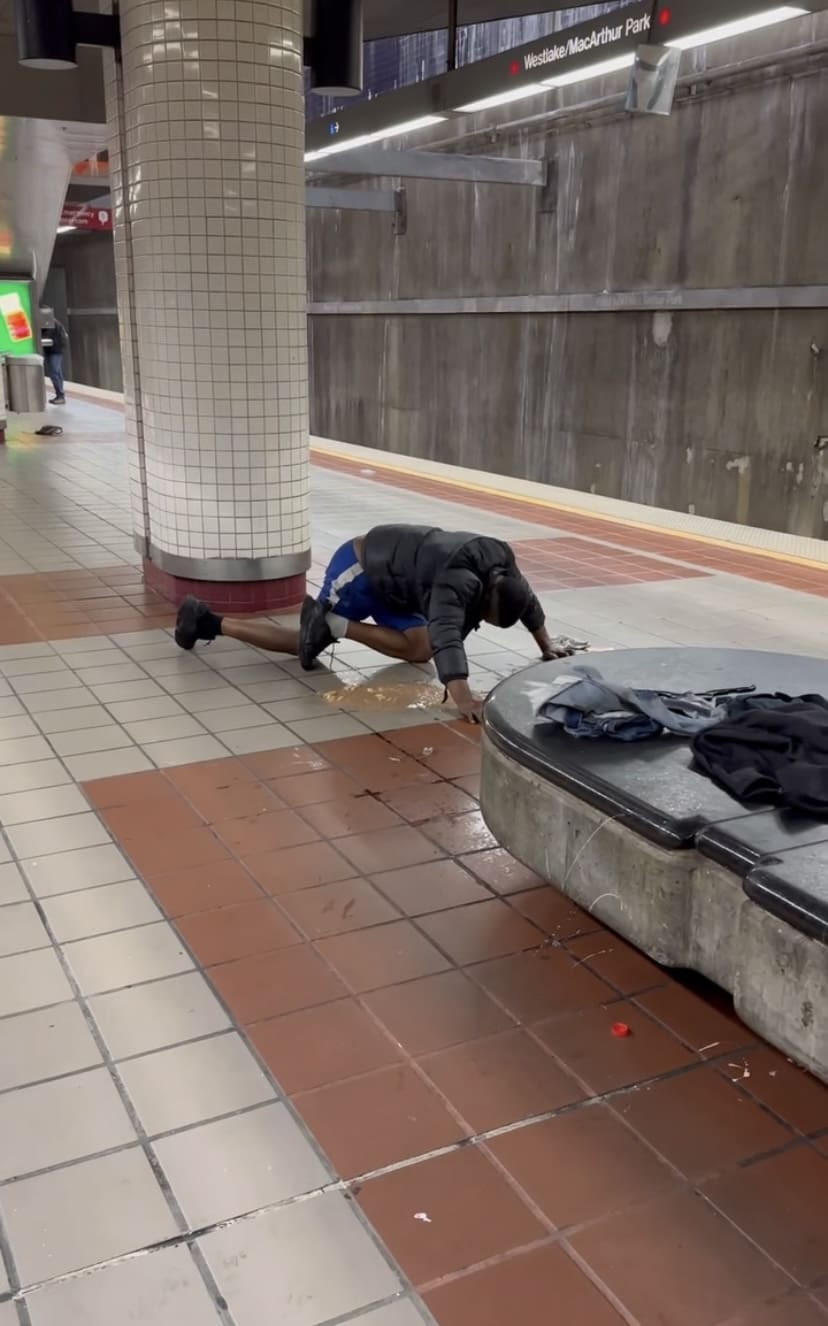 Man vomitting on the floor at LA Metro Station