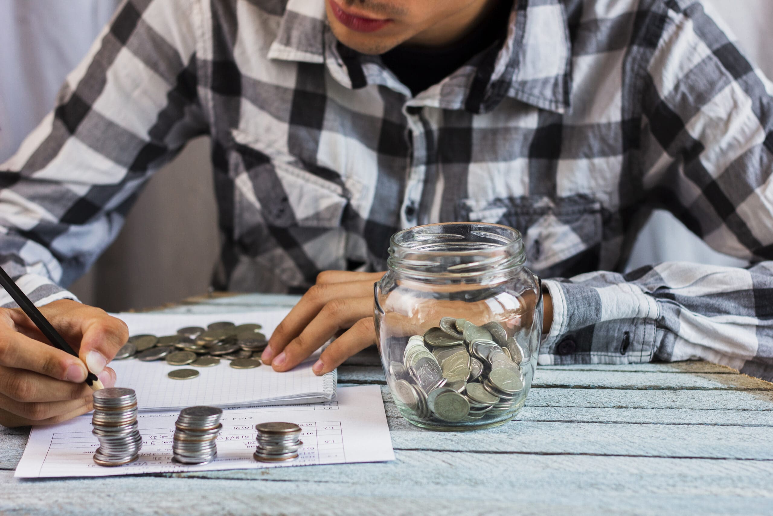 Young man calculating his savings