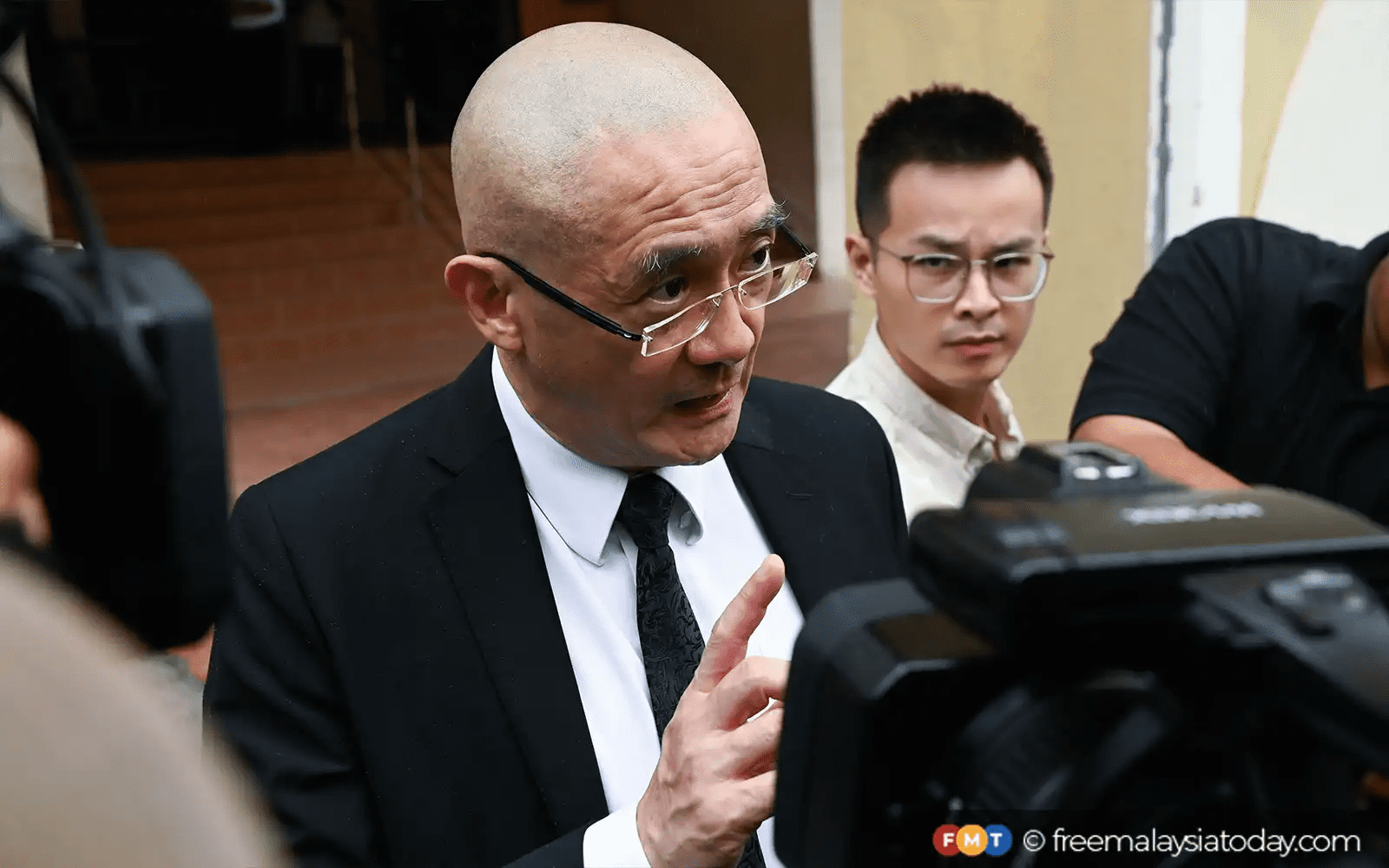 Kitson Foong speaking to reporters about BU case