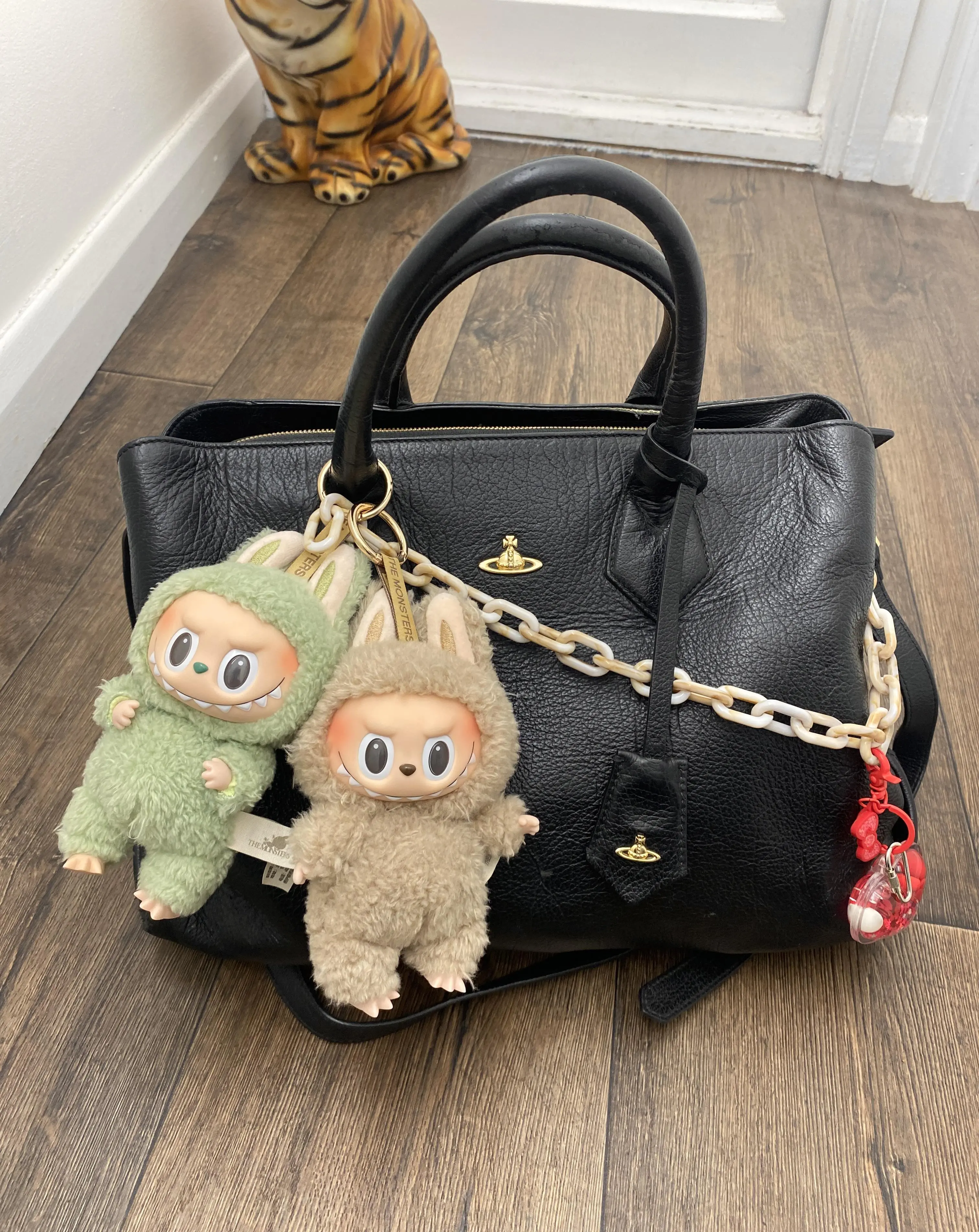 Labubu dolls hanging from bag