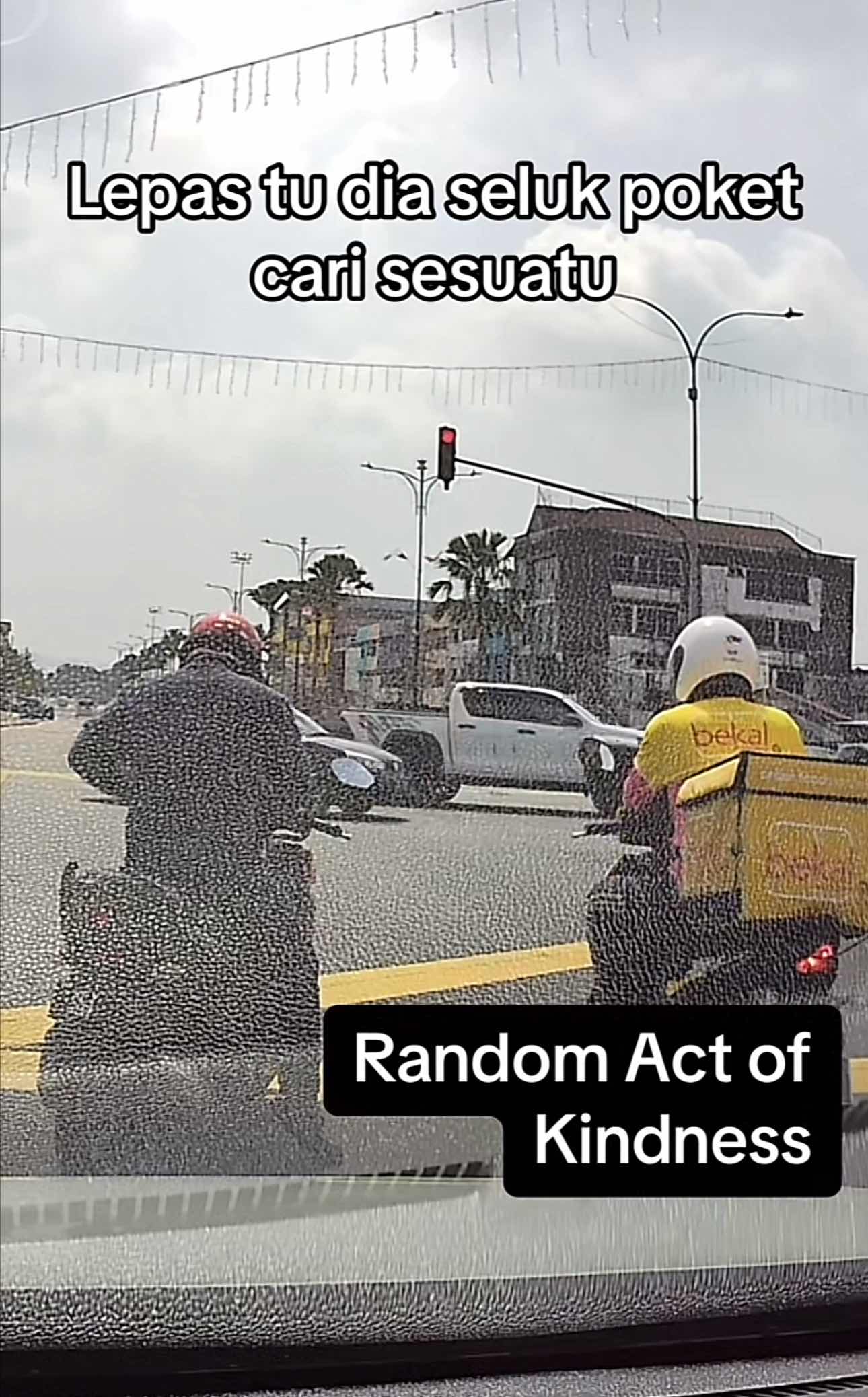 Man looks for money in his pants to offer some money to the delivery rider beside him who brought his kid along