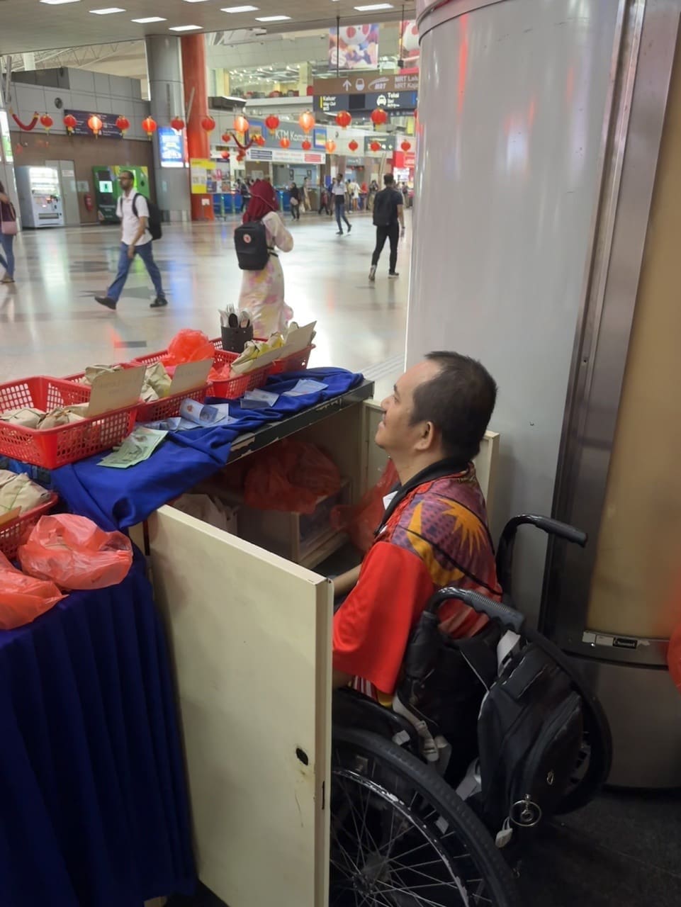 Mohd in a wheelchair selling Nasi Lemak