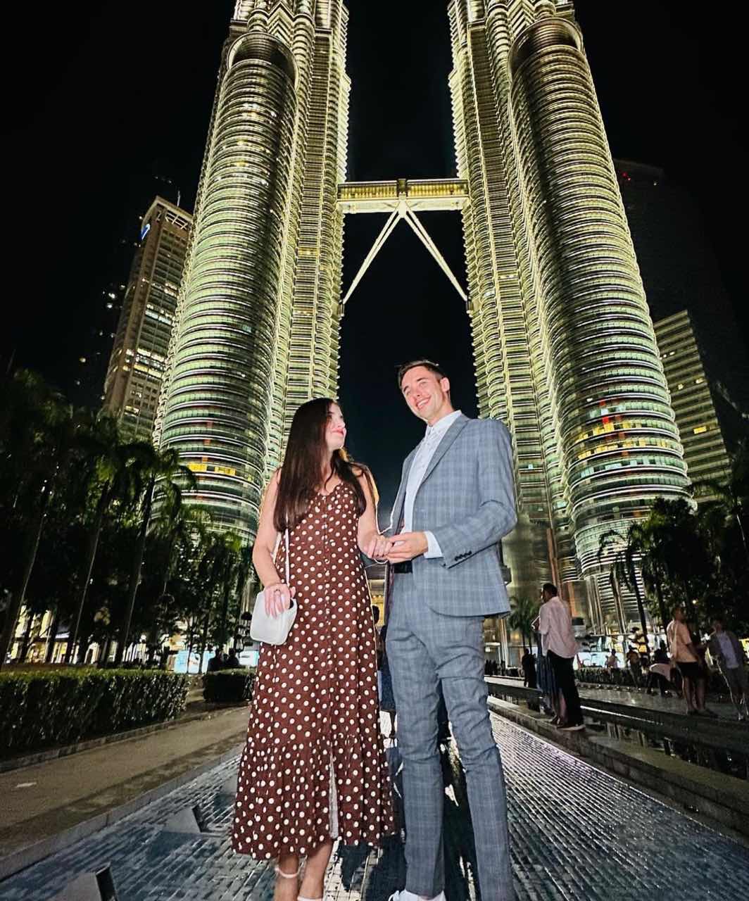 The british man and his wife together near The Twin Towers