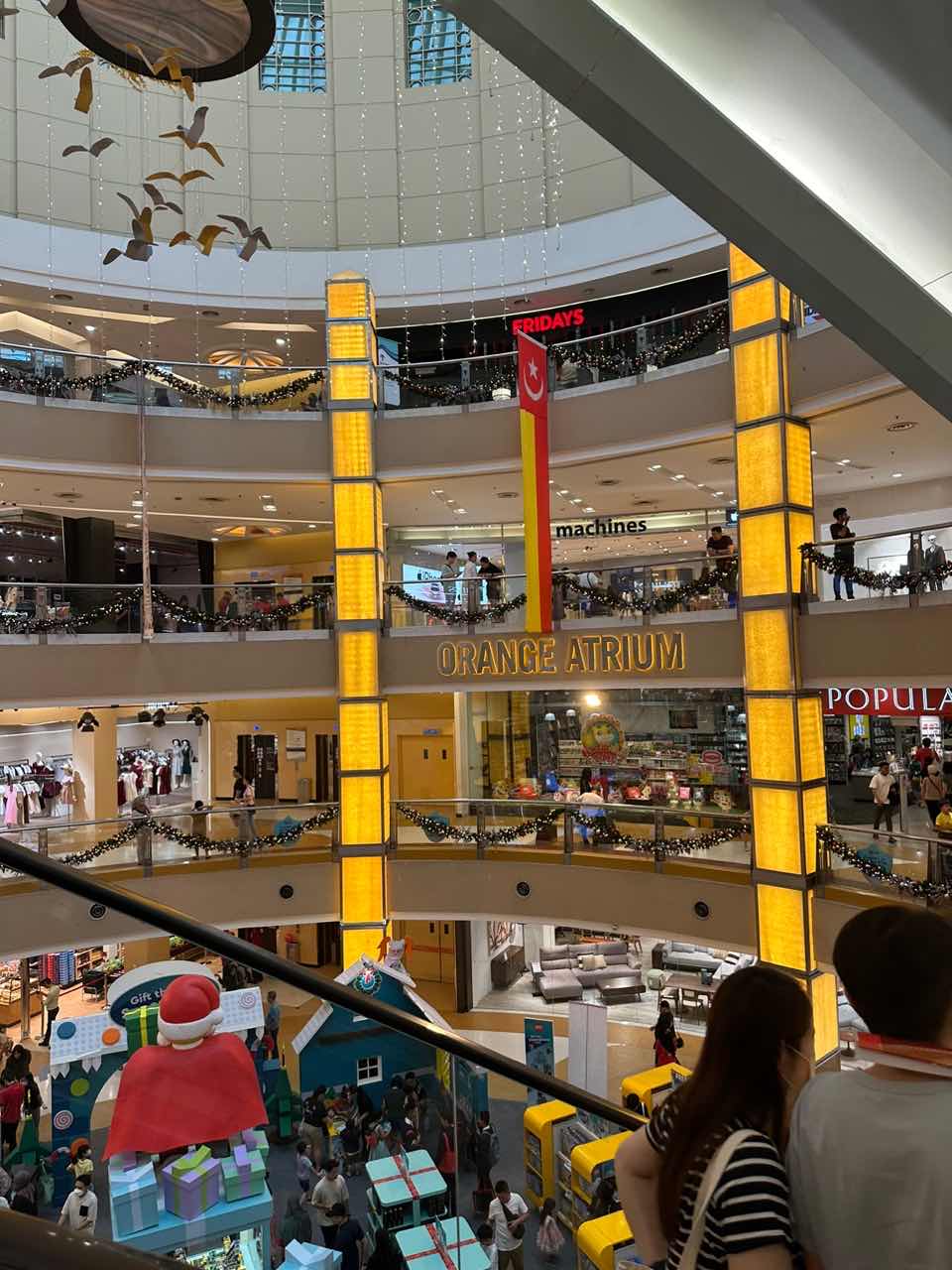 orange atrium at Sunway Pyramid Mall with shoppers all around