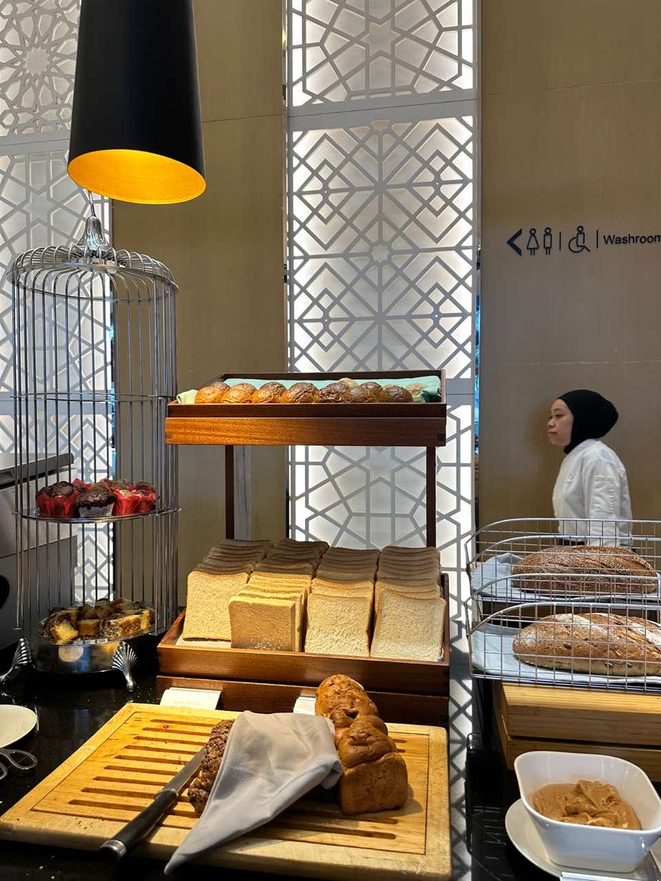 breakfast buffet with many types of bread on the platter