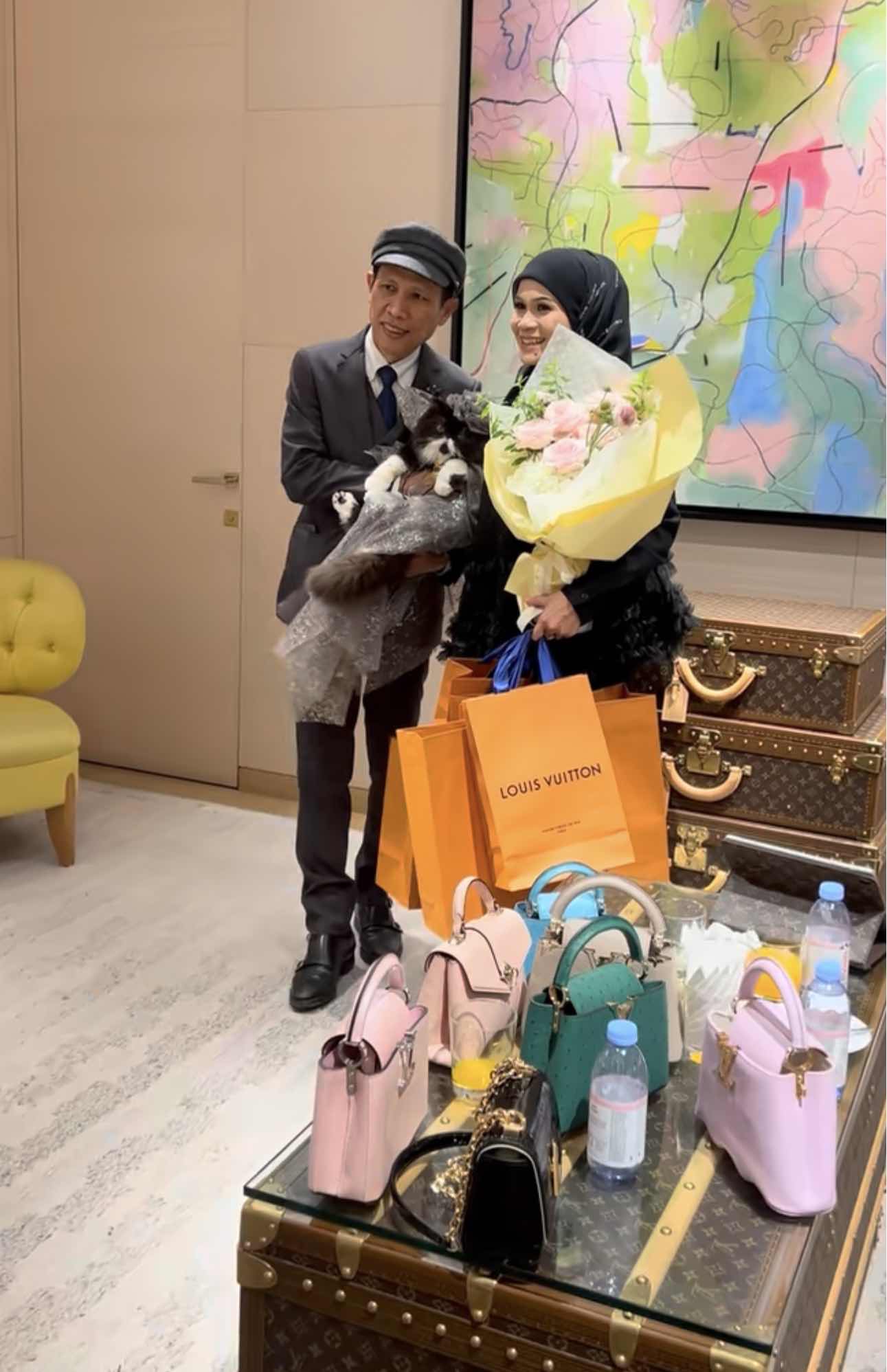 cat's family taking pictures with the gifts and a bouquet