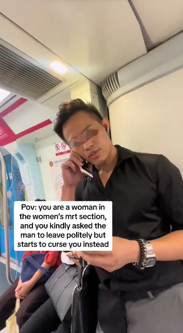 M'sian man talking on the phone at women's coach 