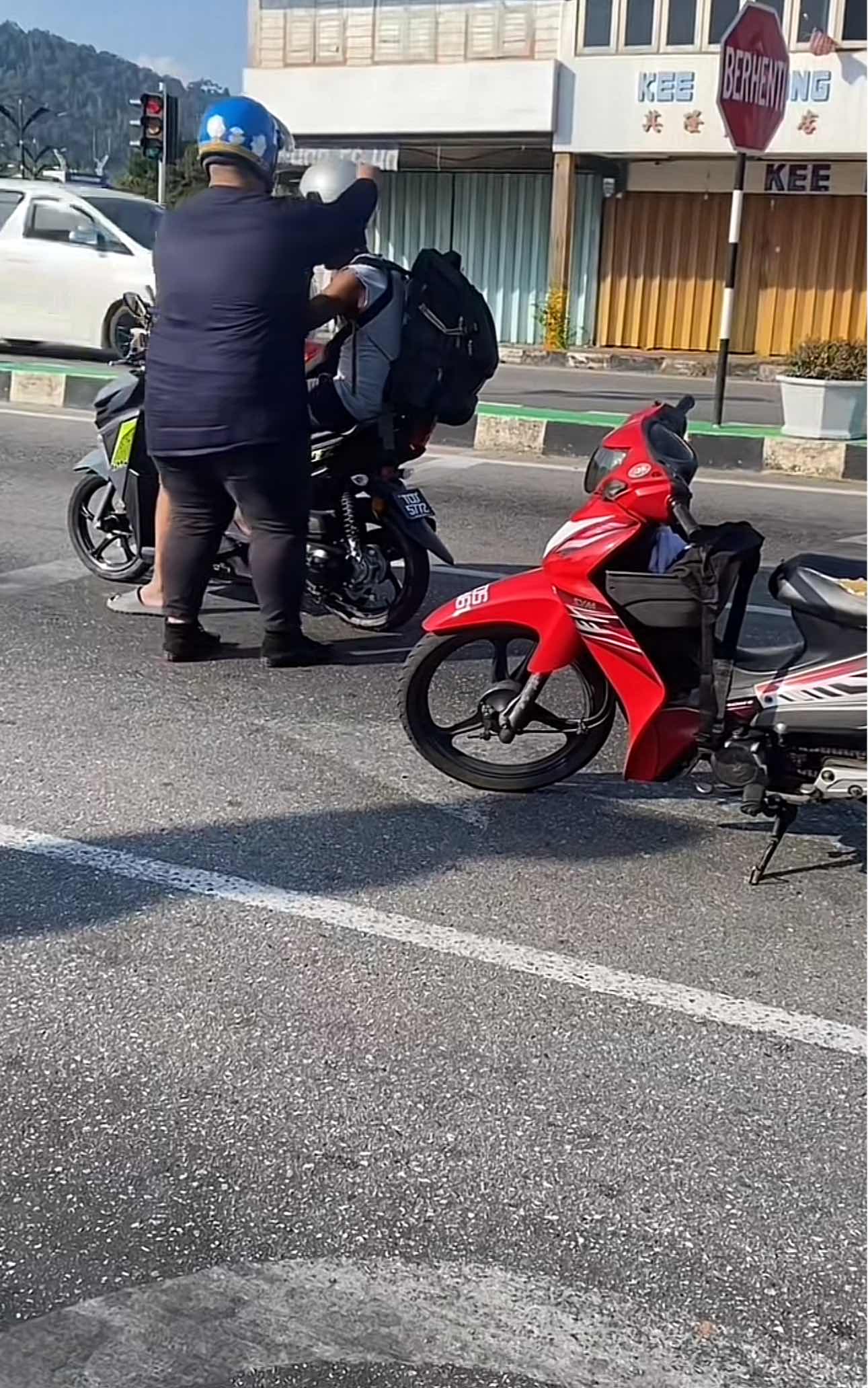 Man adjusts boy's helmet which was upside down