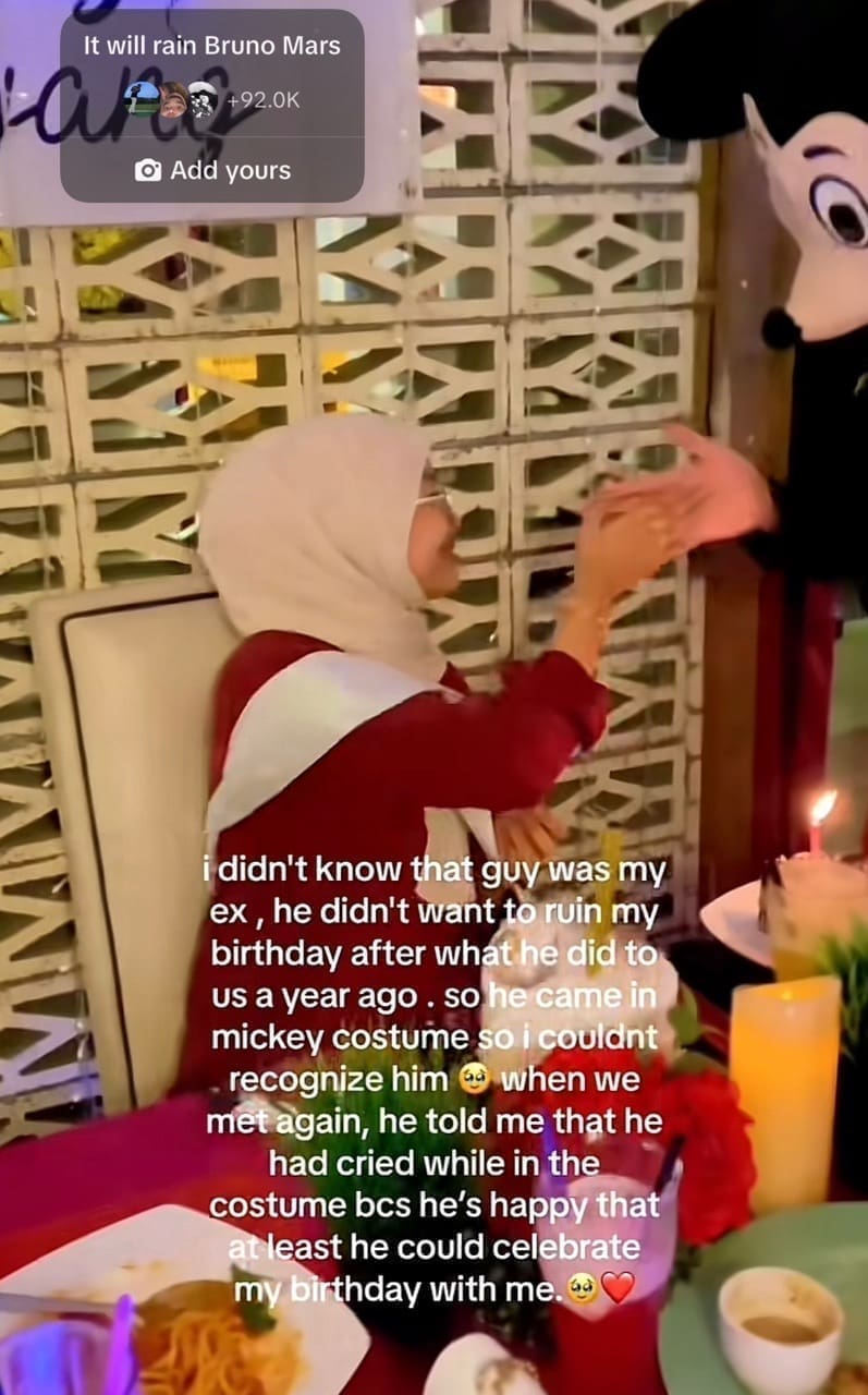 woman gives handshake to the mickey mouse 