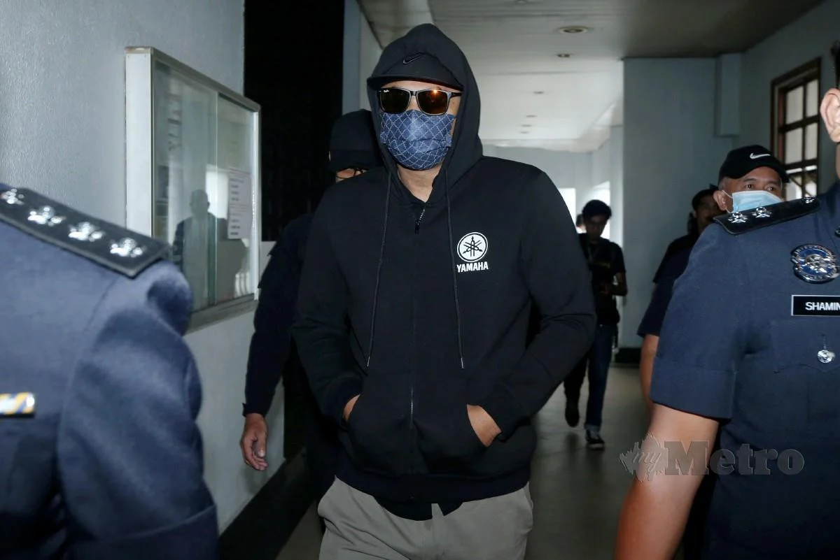 Lance Corporal Mohd Alifah Mohd Sapie coming out from court with policemen 