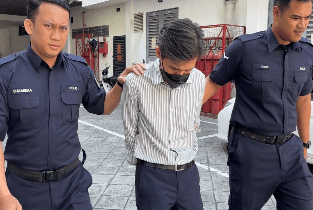 Lau Teik Hwa escorted by police