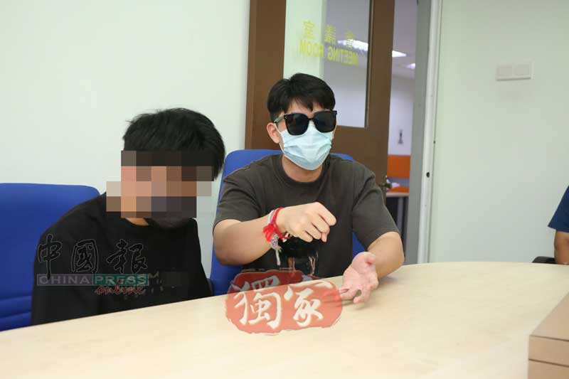 Luo and Ah Luk at the police station
