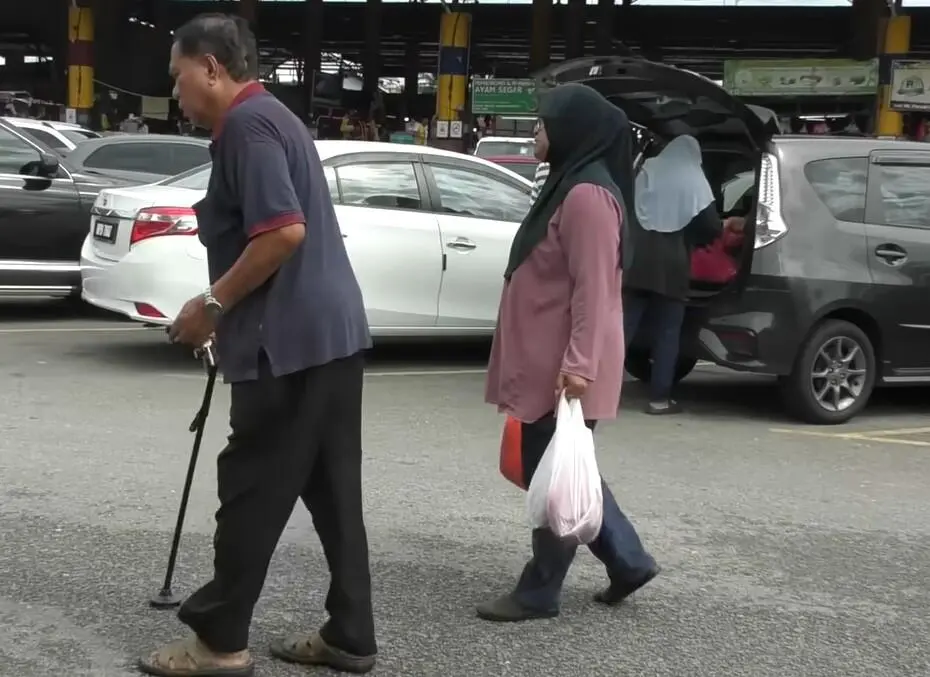 Mahazina helping customers with goods