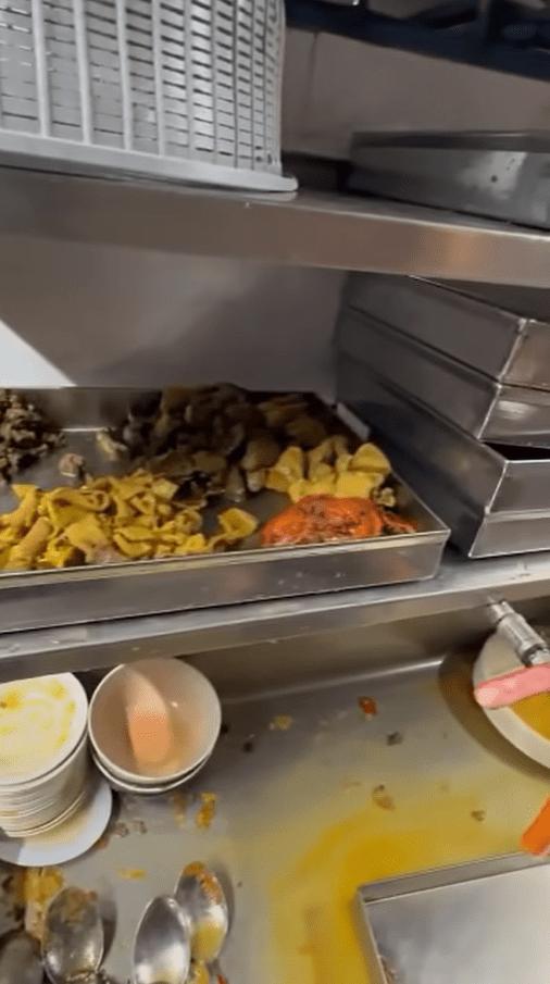 Mamak worker washes leftover food (2)