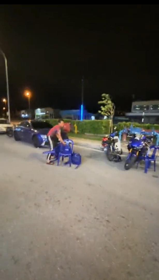 man collecting tables and chairs