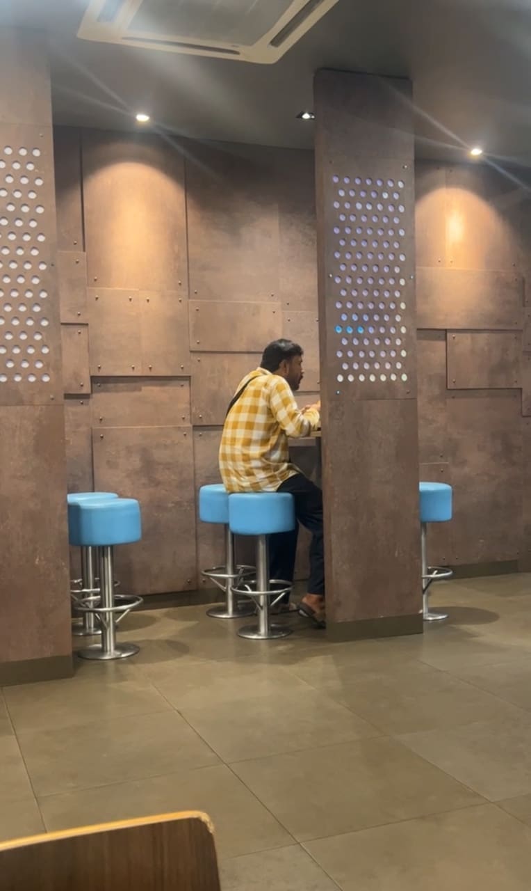 man eating at a fast food restaurant