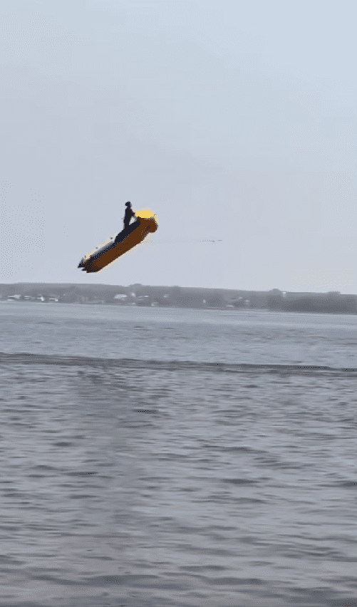 man flying in the air with triple inflatable banana boat