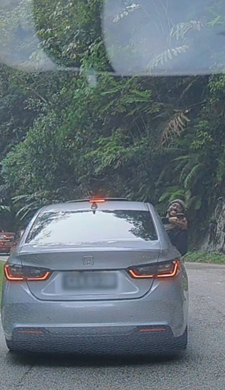 man giving okay signal from his car