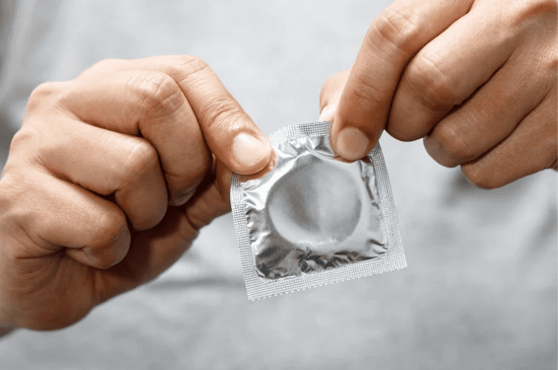 man opening condom