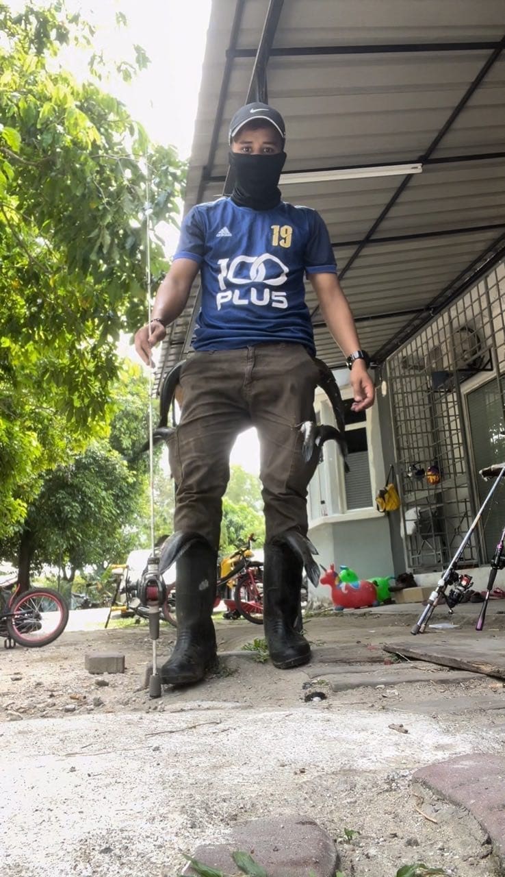 man standing with his fish