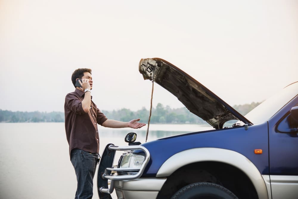 man-try-fix-car-engine-problem-local-road-