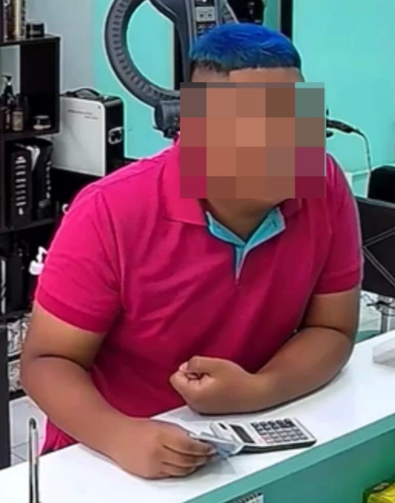 man with blue hair at counter
