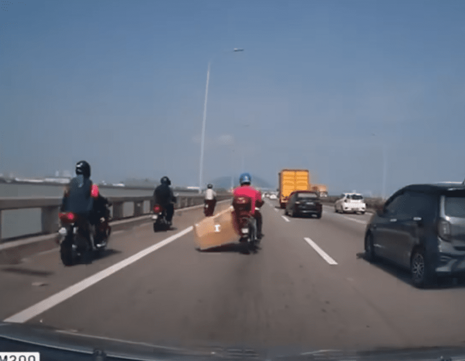 motorcyclist carryinbg a box with him