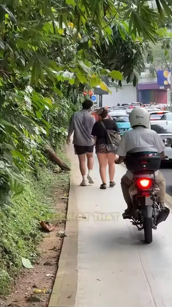 Motorcyclist using same walkway as pedestrian in KL