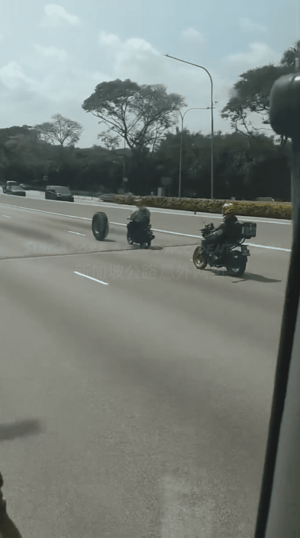Motorcyclists push car tyre on highway in SG