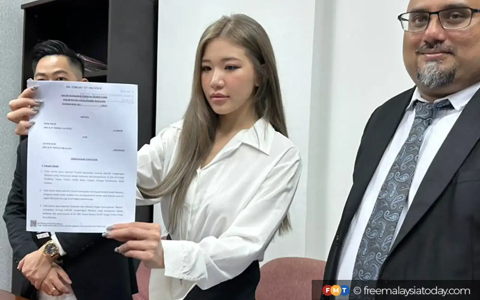 ms puiyi showing her report at the press conference