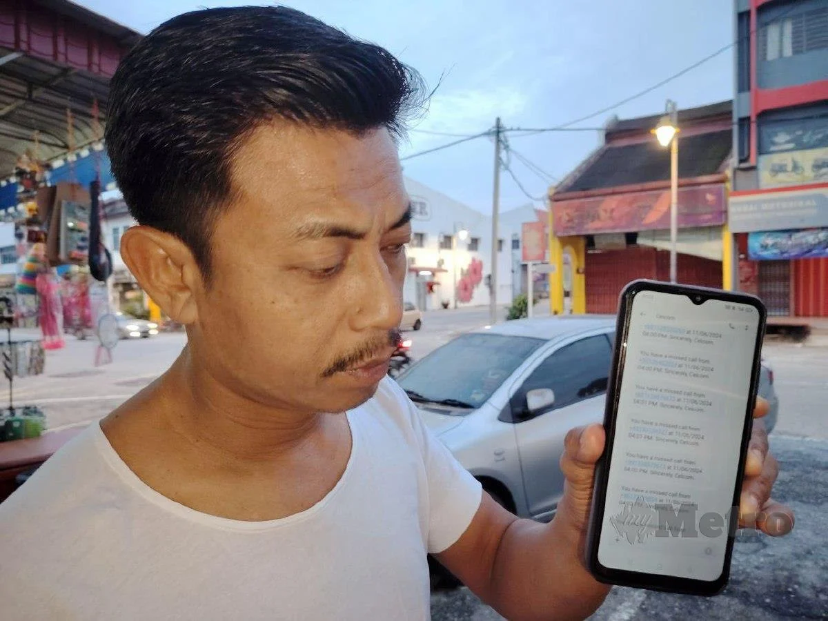 msian man showing his phone