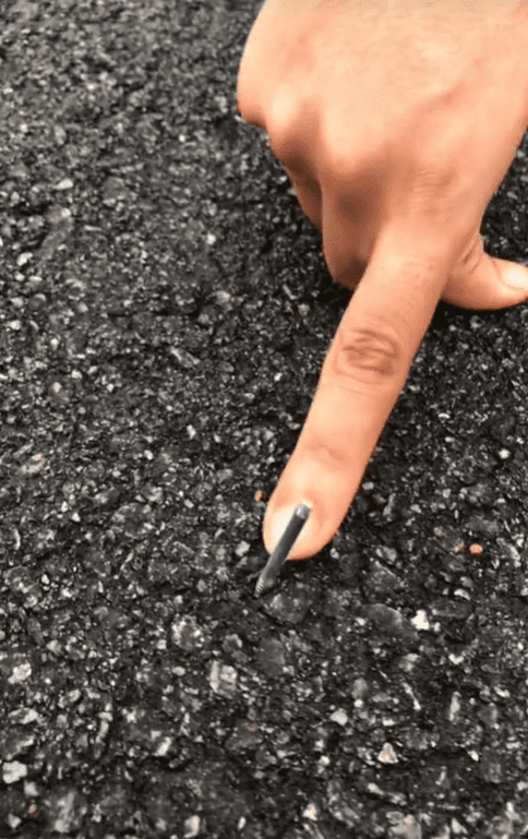 M'sian man shows nail on the road