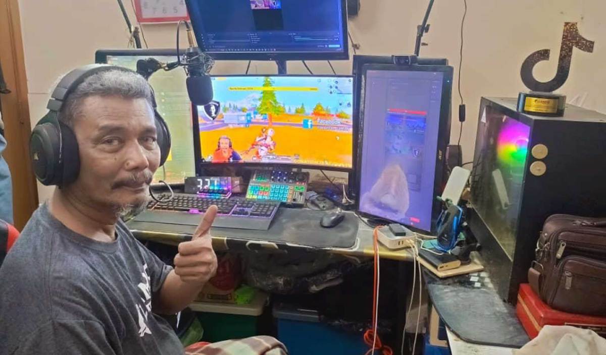 msian man with his gaming setup
