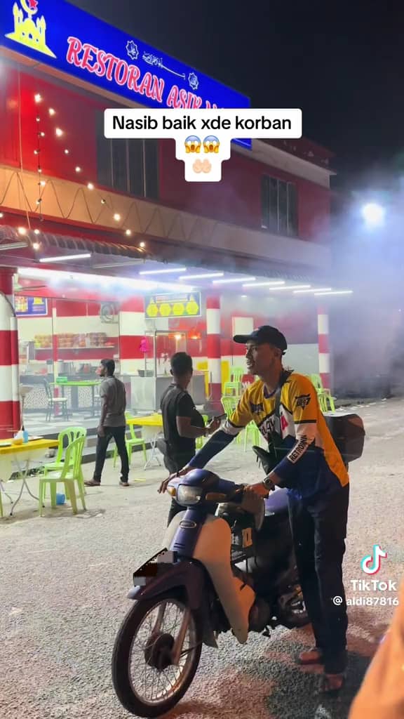 msian moving his motorbike from the fire incident place