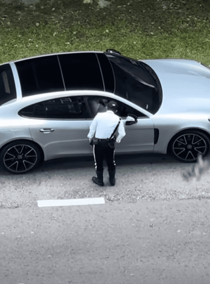 Msian police officer stuffs unknown item into pocket
