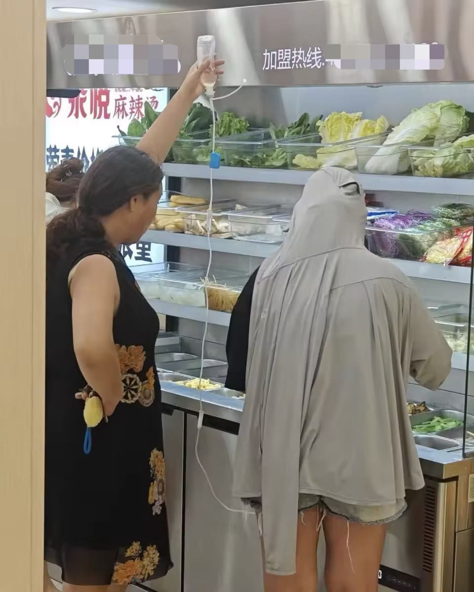 M'sian woman eats at hotpot restaurant with IV drip