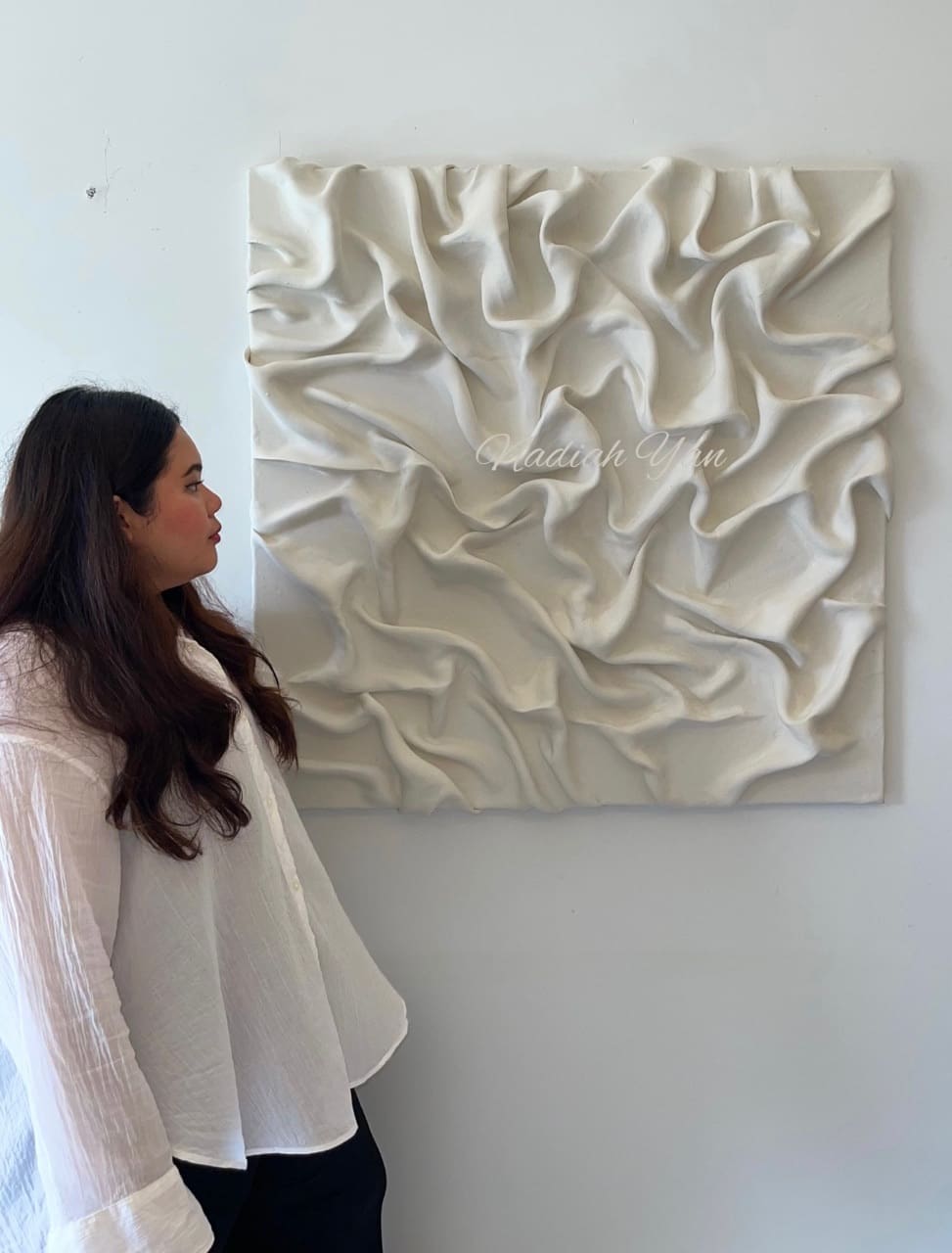 Nadiah Yan looking at a different abstract painting of hers