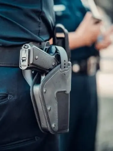 Officer carrying gun with holster