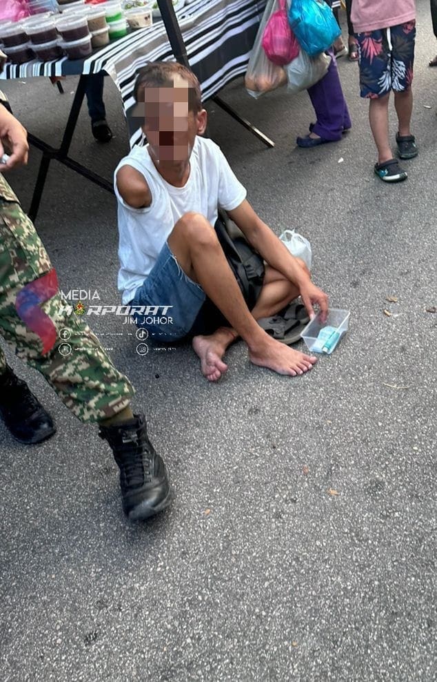 oku man begging at night market in jb