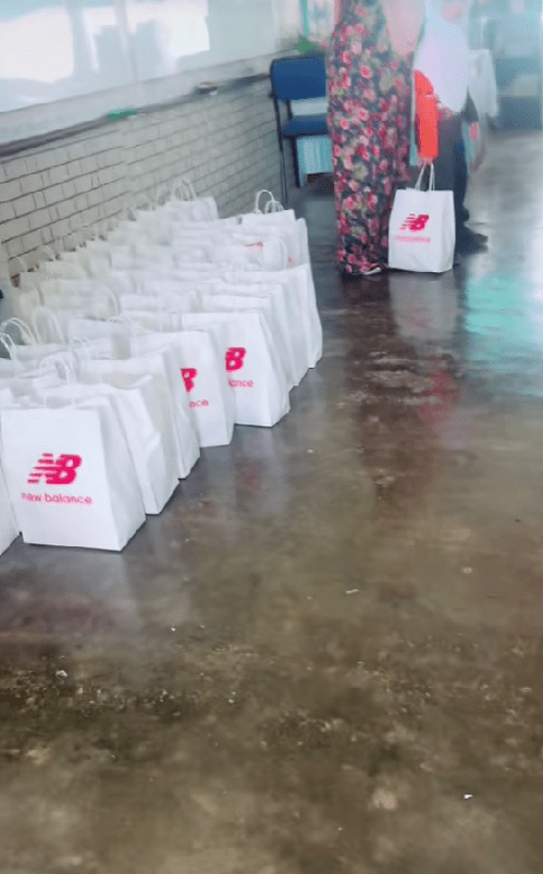 one msian student is holding a bag of new balance shoe gifted by a parent