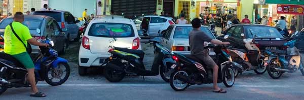 Onlookers gathering outside restaurant where man died inside car