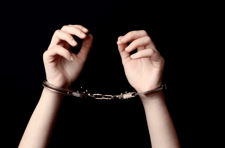 Pair of hands in handcuffs